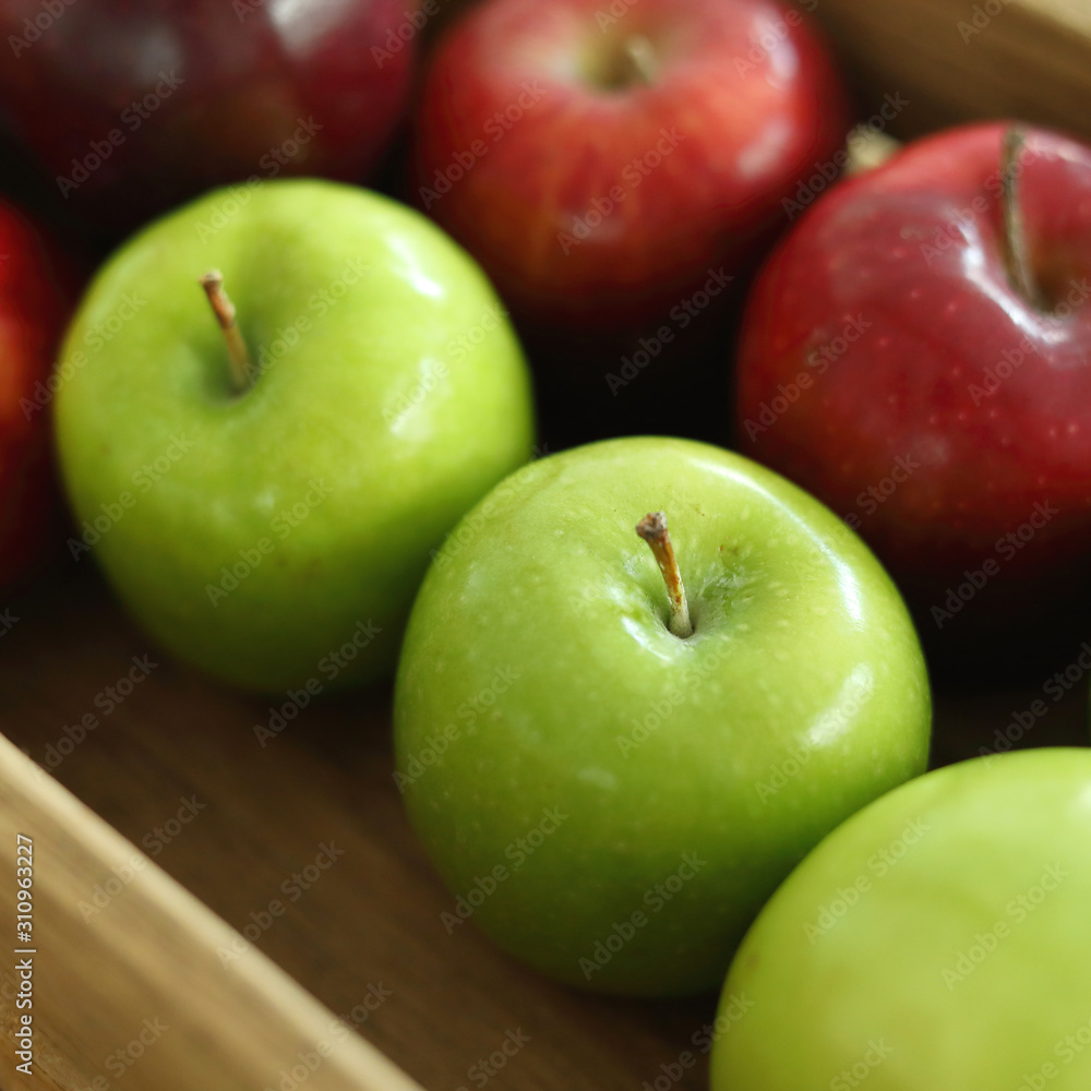red and green apple fruit in harvest wood basket red and green apple fruit in harvest wood basket