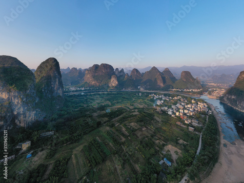 Sunrise over Xingping karsts hills in Xianggong hill and Li river at sunset near Yangshuo in Guanxi province, China photo