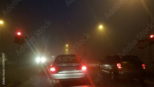 road lights and cars in a foggy night in Ioannina greece