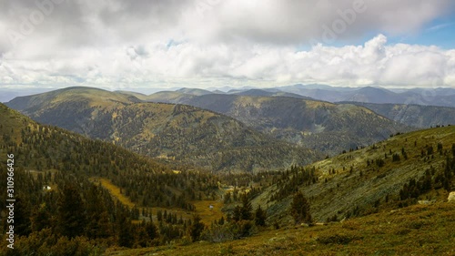Time lapse of changing seasons transition from summer to autumn. Green summer mountain landscape turns into yellow autumn scenery