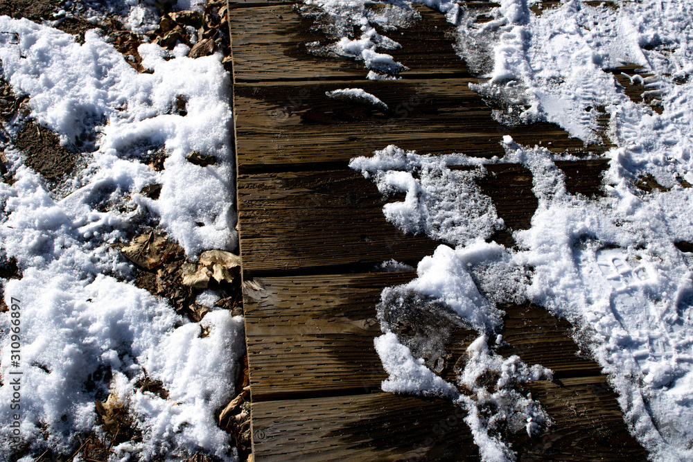 Snow melting on boardwalk