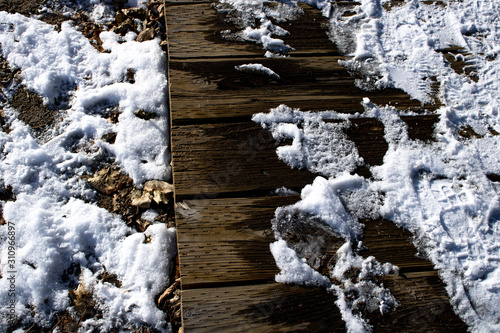 Photography Snow melting on boardwalk