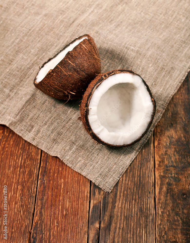 Pieces of coconut on old wooden background. Top view. Text space. Pieces of coconut on old wooden background. Top view. Text space.