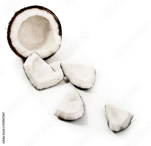 Half coconut and coconut pieces isolated on white background
