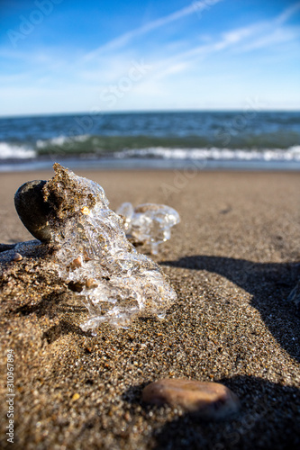 Photography Frozen shapes of rock and sand in the beach in the winter