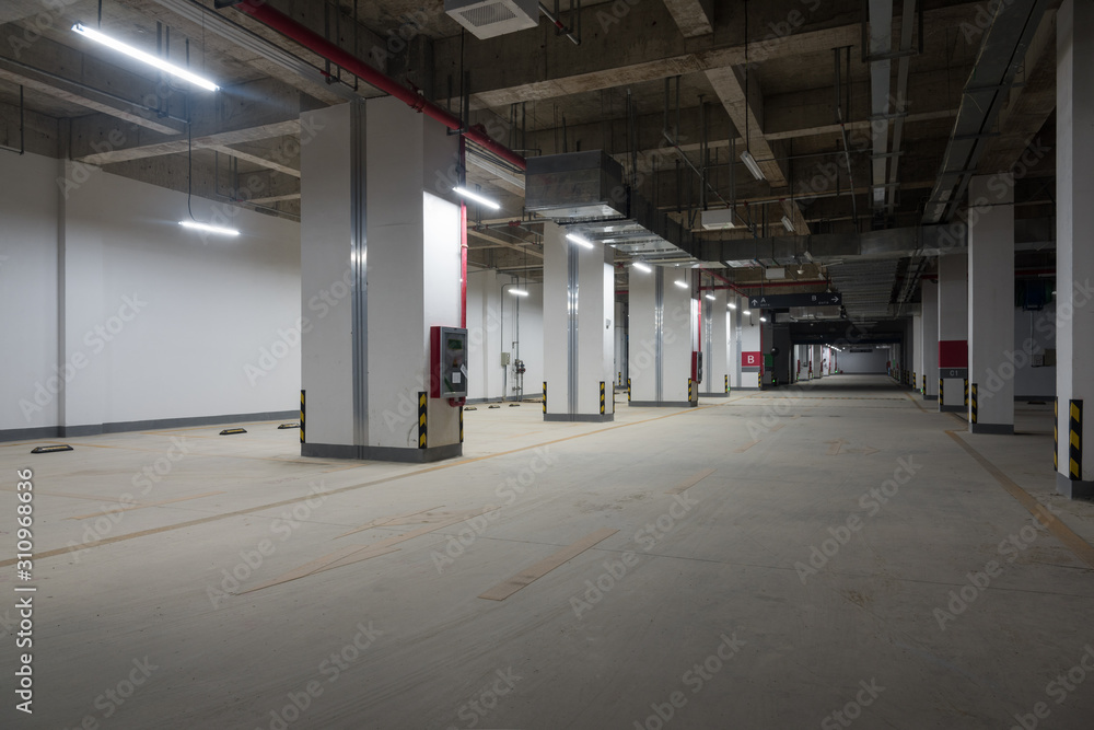 Perspective view of car passage in large underground parking lot