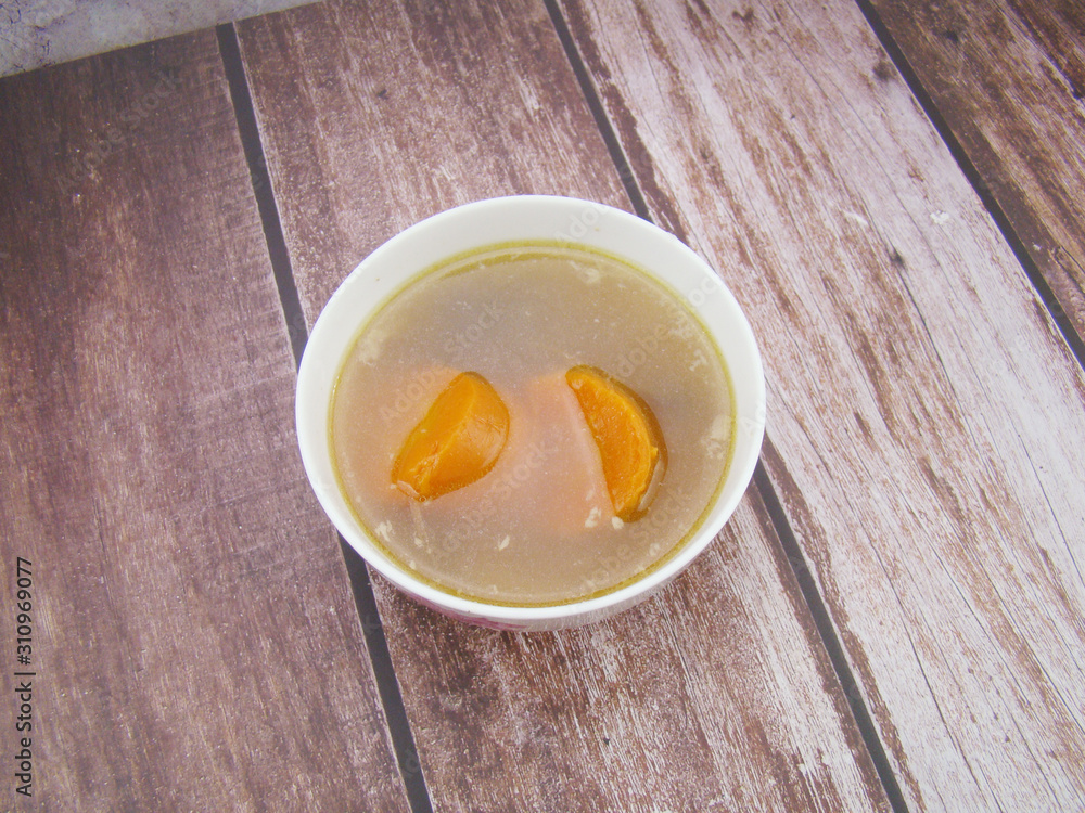 Chinese tableware carrot stew chicken soup on wooden board Chinese tableware carrot stew chicken soup on wooden board
