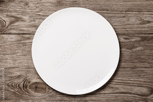 White ceramic tray on a wooden table, top view. Food background