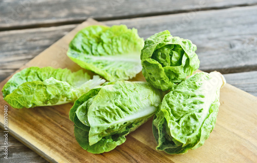 a lot of fresh Romaine lettuce on wooden floor..Healthy and benefits of green leaf lettuce.