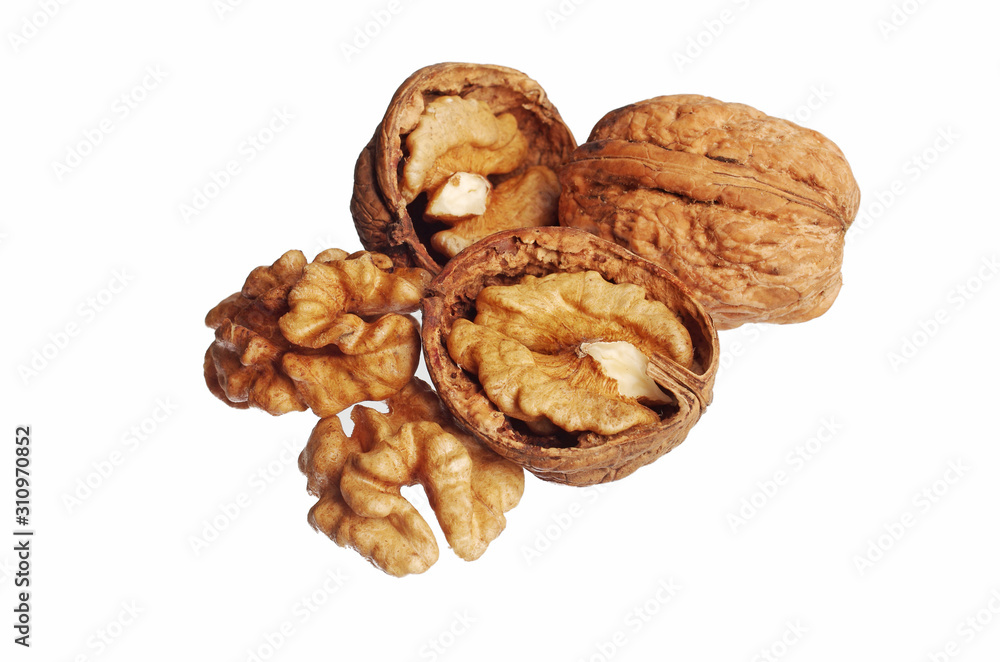Walnut kernels and shell nuts on a wooden table. Close-up. Isolated on white. Walnut kernels and shell nuts on a wooden table. Close-up. Isolated on white.