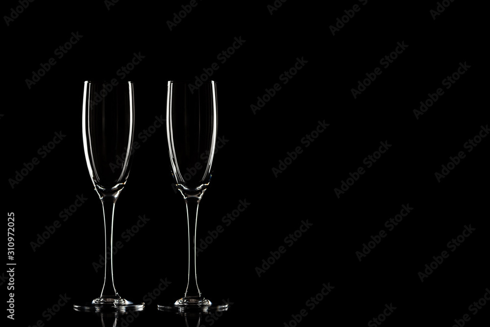 Empty champagne glasses on a black background