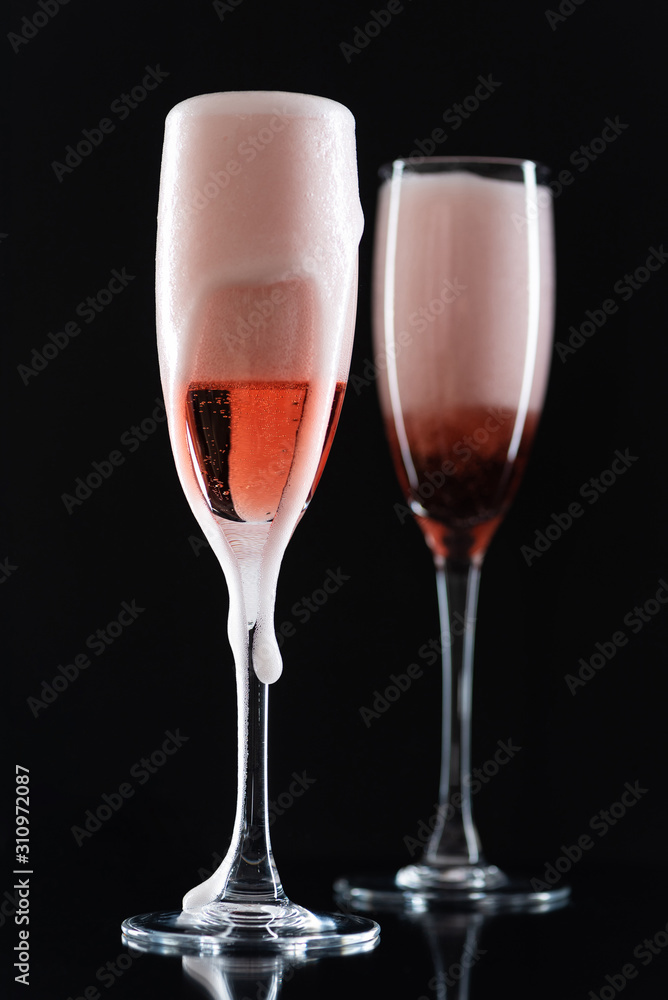 Rose champagne in a glass on a black background