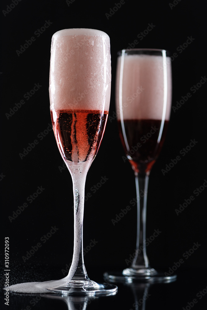 Rose champagne in a glass on a black background