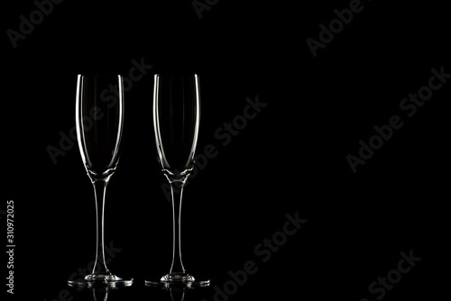 Empty champagne glasses on a black background