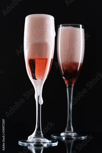 Rose champagne in a glass on a black background