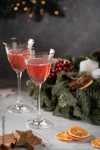 Rose champagne in a glass on the background of a Christmas wreath