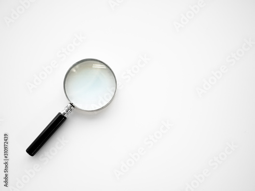 Silver magnifying glass equipment tool for enlarge zoom to search and focus on object or discovery small thing through quality optical lens on isolated white background