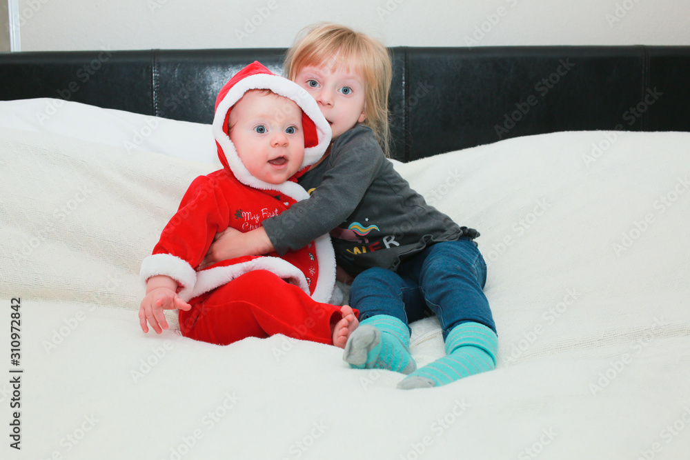 Close up Portrait of Cute Little 9 Month Old Baby Girl and 3 Years Old Toddler Girl, Two Sisters, Happy and Healthy Kids Close up Portrait of Cute Little 9 Month Old Baby Girl and 3 Years Old Toddler Girl, Two Sisters, Happy and Healthy Kids