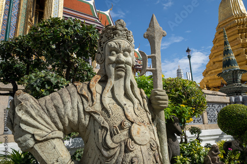 God guard statue outside at the ancient Grand Palace in Bangkok Thailand