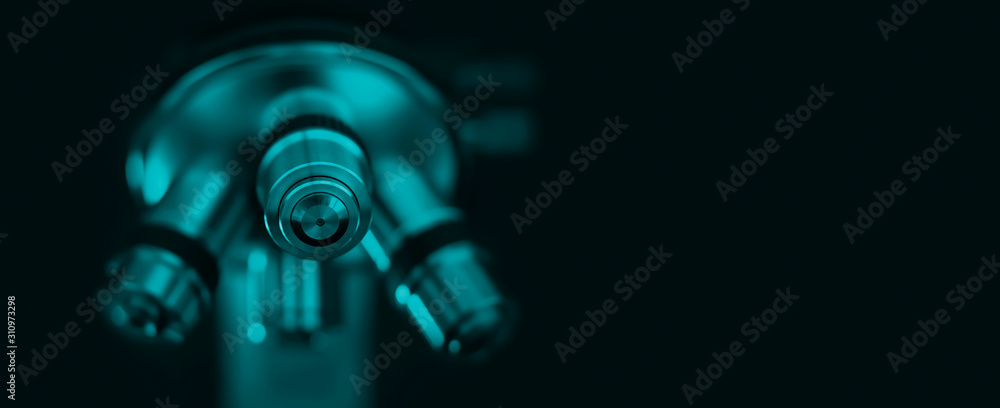 Microscope on a blue background. Scientific and laboratory equipment.