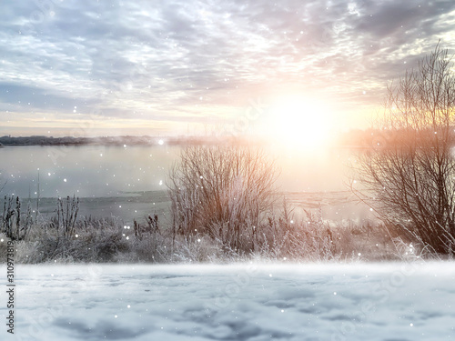 Winter background. Winter sun, ray, glare. Winter landscape with a river, snow, sunlight. © MiaStendal