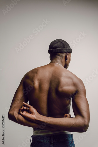 Rear view of muscular shirtless model