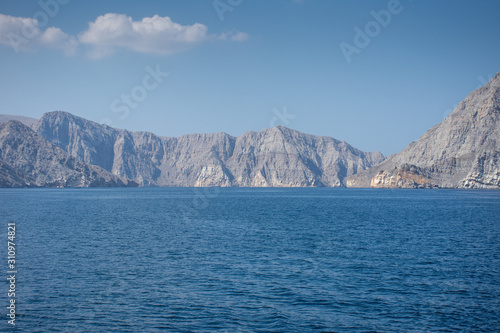 Spectacular rocky mountains of northern Oman in Musandam in the fjords on tourist Dhow Boat trips.