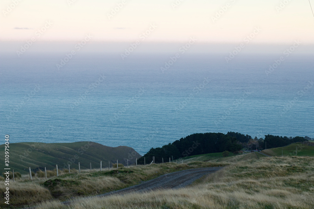 Fototapeta premium Late afternoon. Akaroa, New Zealand. Gravel road.