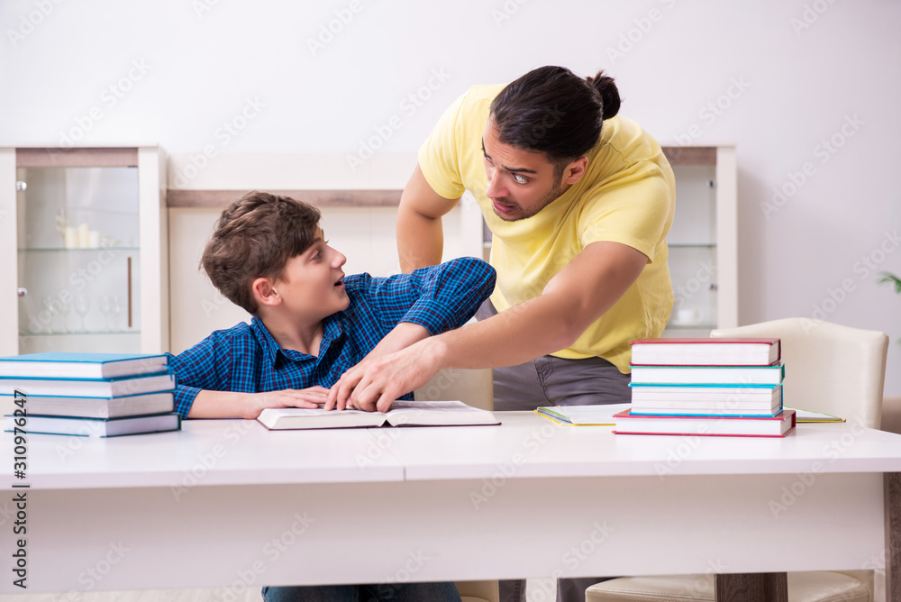 Father helping his son to prepare for school Father helping his son to prepare for school