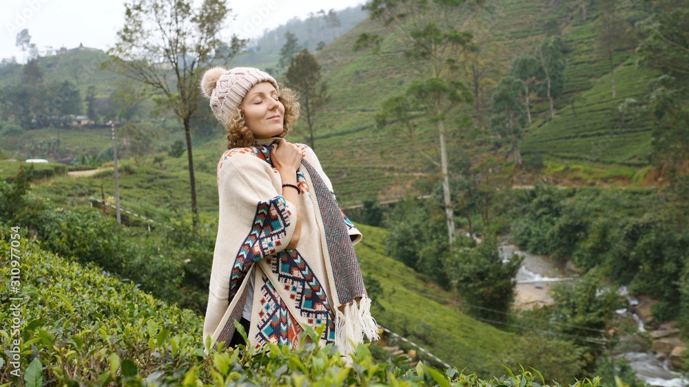 Naklejka premium Happy Woman Traveler In Green Mountains