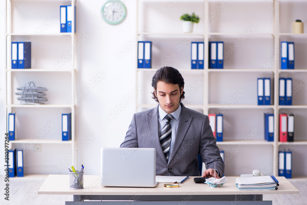 Young handsome businessman working in the office