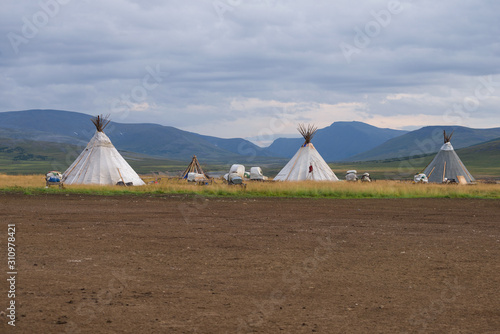 A camp of modern nomadic reindeer herders against the backdrop of the mountains of the Polar Urals. Yamal-Nenets Autonomous Okrug  Russia