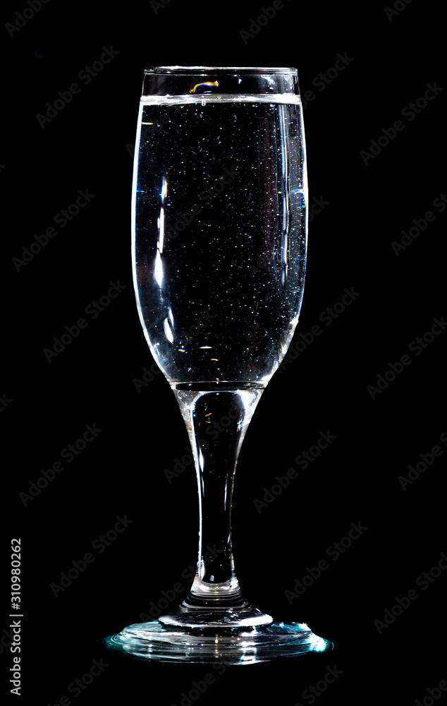 Water in a glass on a black background