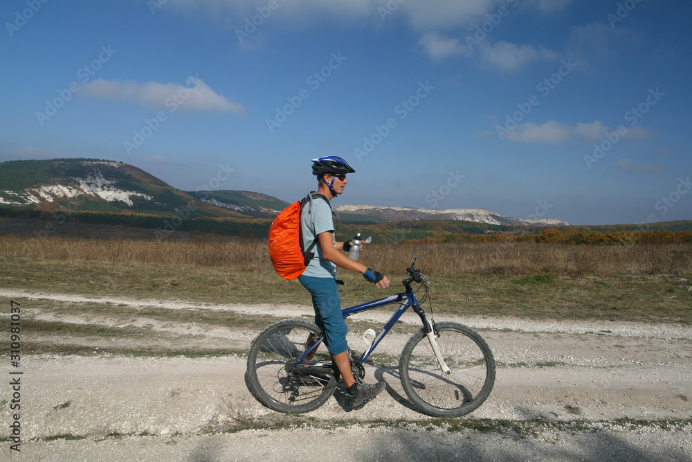 Cyclist on the background of the Crimean mountains, Russia.