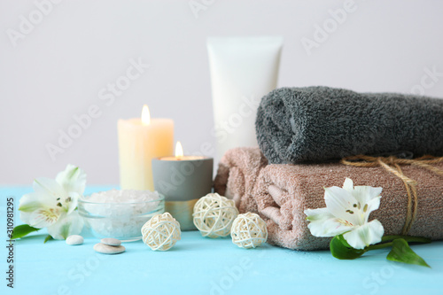 spa composition with towels and flowers on the table with place for text. Body care, relaxation