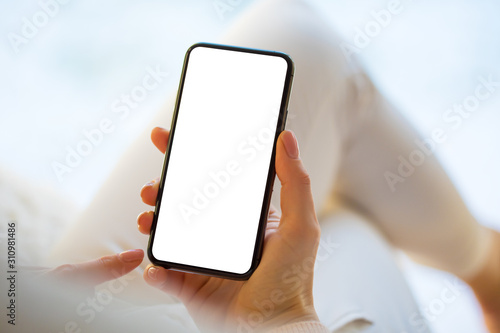 Woman using mobile phone at home. Smartphone screen mockup.