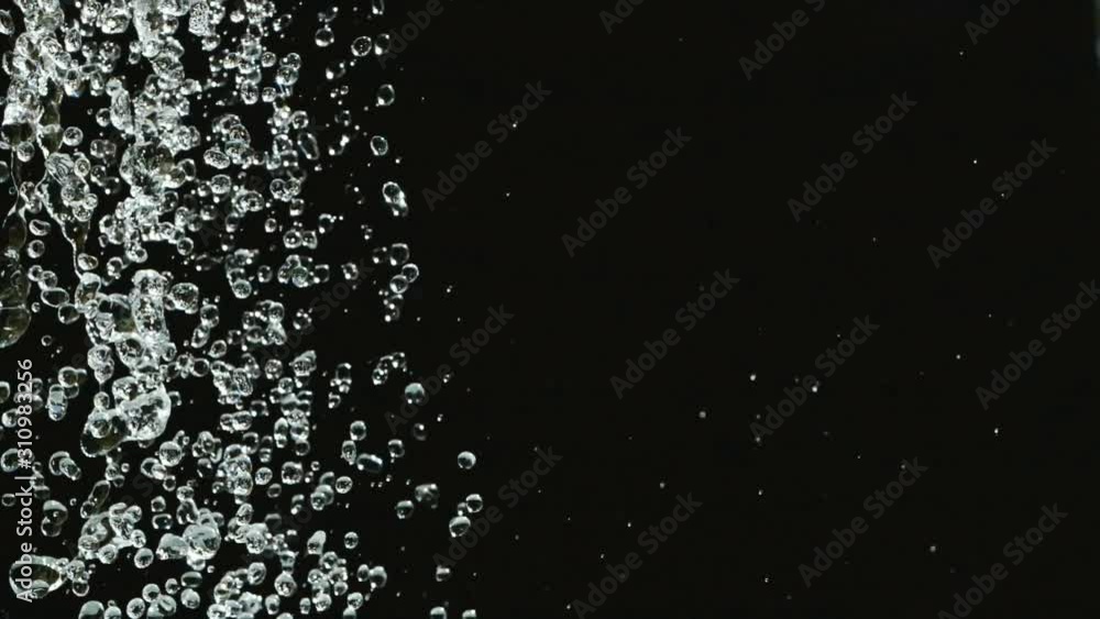 Falling water drops in slow motion on black background. Falling shower droplets against Black Background. Falling water drops in slow motion on black background. Falling shower droplets against Black Background.