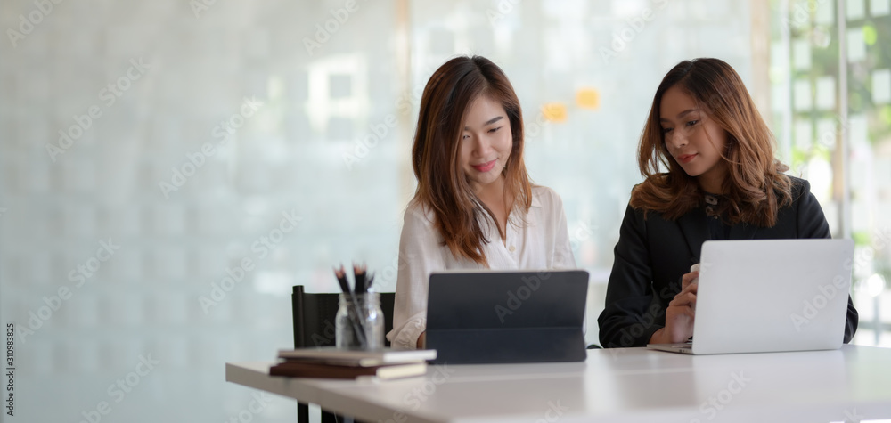 Cropped shot of young professional businesswoman discussing the project together Cropped shot of young professional businesswoman discussing the project together