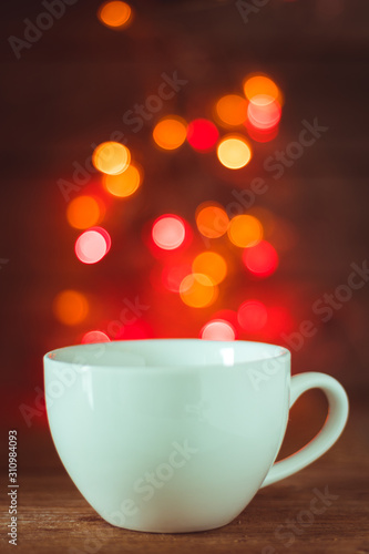 White coffee cuo on wooden tavle with bokeh background
