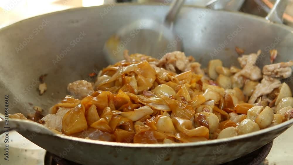 Frying noodle with chopped pork and Chinese kale in pan, Thai street food Frying noodle with chopped pork and Chinese kale in pan, Thai street food