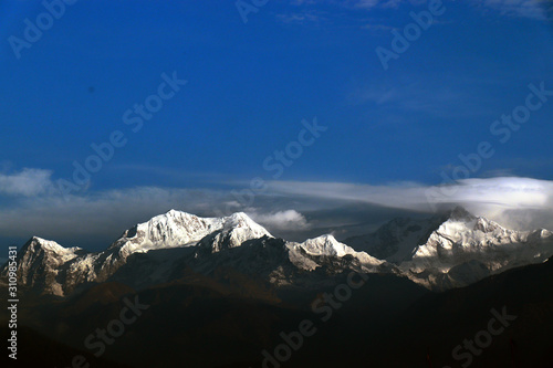 Kanchanjungha during golden hour, snow, peak, landscape, nature, Himalayan. Snowy mountains of Himalaya. A beautiful snowy mountain landscape under a blue cloudy sky.. photo