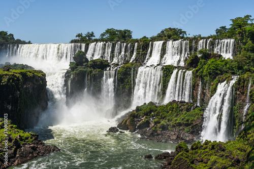 Famous Iguazu waterfalls with beautiful clouds. Declared a World heritage and one of the seven Natural Wonders of the World Brasil Argentina. Iguazu National Park