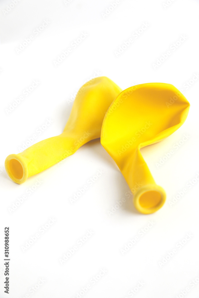 Deflated yellow balloon isolated on a white background Deflated yellow balloon isolated on a white background