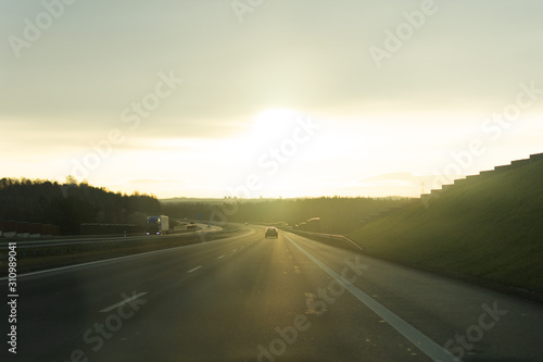 Sunrise on the road from the car window. © Inna Dodor