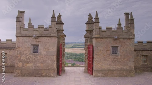 Medium low angle daytime still shot of opened red gates of the Little Castle, and horizon landscape view, Bolsover Castle in Derbyshire, UK photo