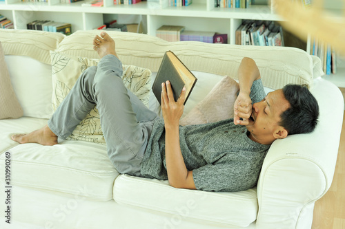 Portrait of Asian man reading book at reading room