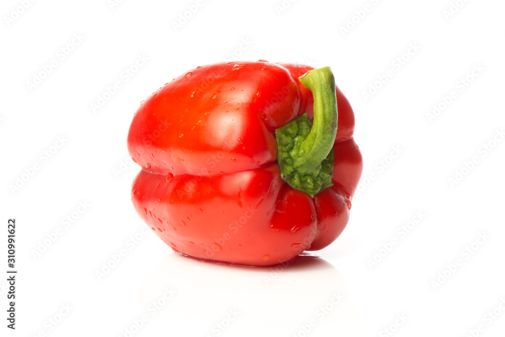A fresh red pepper is isolated on a white background. A fresh red pepper is isolated on a white background.