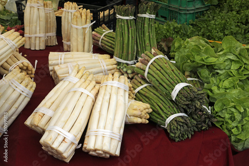 many bunches of asparagus at a market stall photo