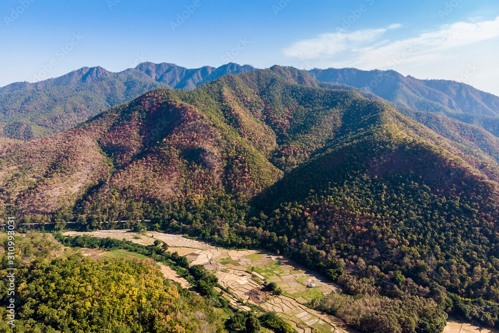 Beautiful mountains with forest skyline and clouds at Winter day.