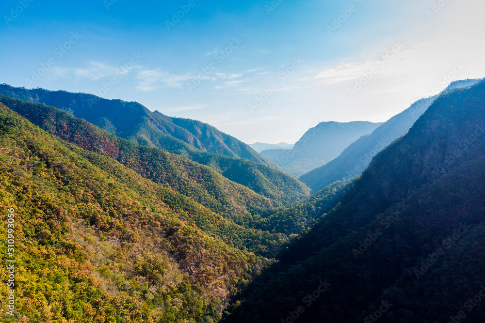 Beautiful mountains with forest skyline and clouds at Winter day.